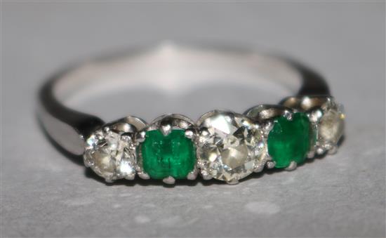 A diamond and emerald five stone ring.